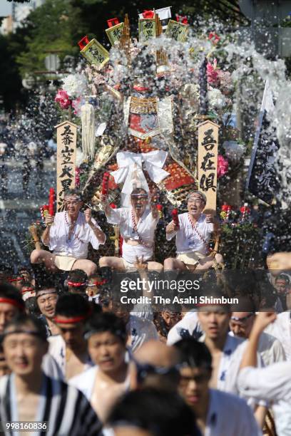 Daikoku Nagare' members run with a Hikiyama float during the 'Shudan Kaomise' event as a part of the Hakata Gion Yamakasa on July 13, 2018 in...