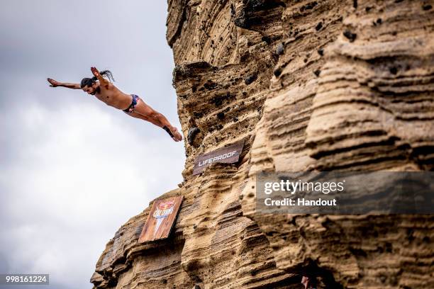 In this handout image provided by Red Bull, Orlando Duque of Colombia dives from a 27 metre cliff face on Islet Vila Franco do Campo during the first...