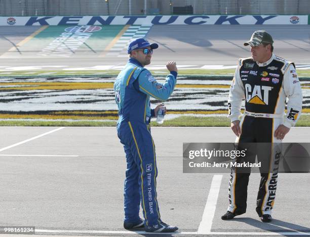 Ryan Newman, driver of the Caterpillar Chevrolet, talks to Ricky Stenhouse Jr., driver of the Fifth Third Bank Ford, on the grid during qualifying...