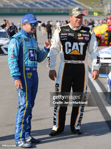 Ryan Newman, driver of the Caterpillar Chevrolet, talks to Ricky Stenhouse Jr., driver of the Fifth Third Bank Ford, on the grid during qualifying...