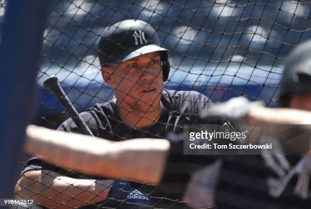 Aaron Judge of the New York Yankees looks on from behind the batting cage during batting practice before the start of MLB game action against the...