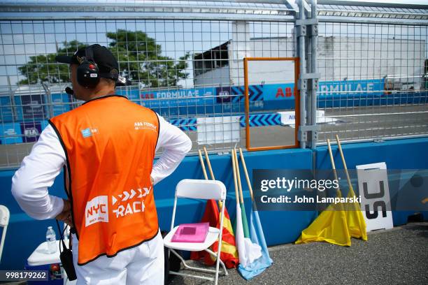 Track official is seen with flags on the racing track during the Formula E New York City Race on July 13, 2018 in New York City.