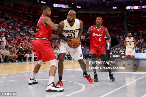 Josh Powell of the Killer 3's handles the ball while being guarded by James White and Derrick Byars of Trilogy during BIG3 - Week Four at Little...