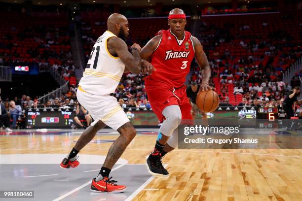 Al Harrington of Trilogy dribbles the ball while being guarded by Josh Powell of the Killer 3's during BIG3 - Week Four at Little Caesars Arena on...