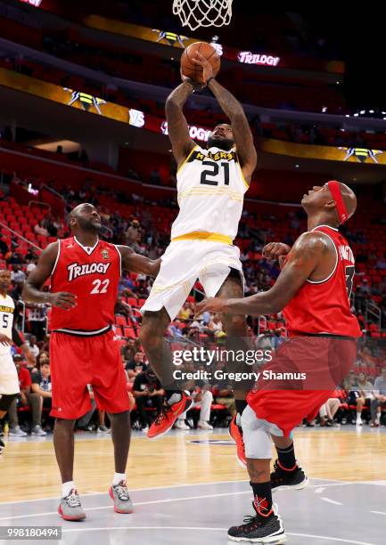 Josh Powell of the Killer 3's attempts a shot between Dion Glover and Al Harrington of Trilogy during BIG3 - Week Four at Little Caesars Arena on...