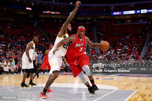 Al Harrington of Trilogy dribbles the ball while being guarded by Josh Powell of the Killer 3's during BIG3 - Week Four at Little Caesars Arena on...