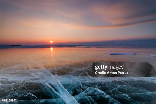 sunset on the ice of lake baikal - irkutsk stock pictures, royalty-free photos & images