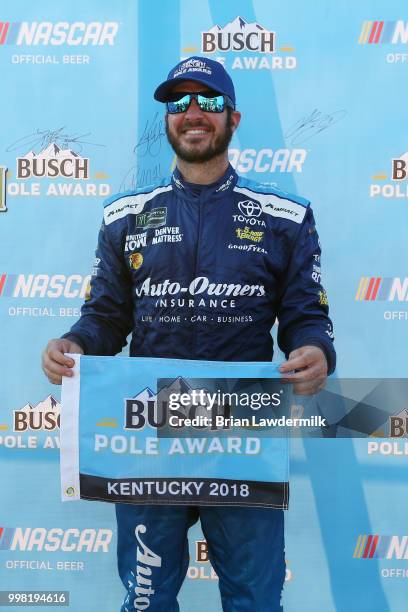 Martin Truex Jr., driver of the Auto-Owners Insurance Toyota, poses with the Busch Pole Award after qualifying for the pole position for the Monster...