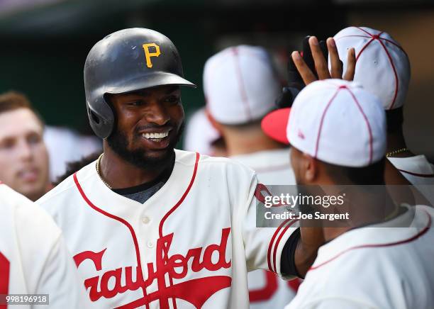 Gregory Polanco of the Pittsburgh Pirates celebrates his RBI with teammates during the first inning against the Milwaukee Brewers at PNC Park on July...