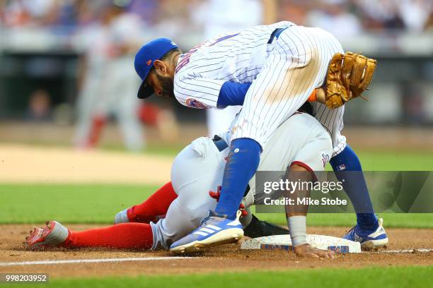 Wilmer Difo of the Washington Nationals is tagged out at third base by Jose Bautista of the New York Mets on a fielders choice in the third inning at...
