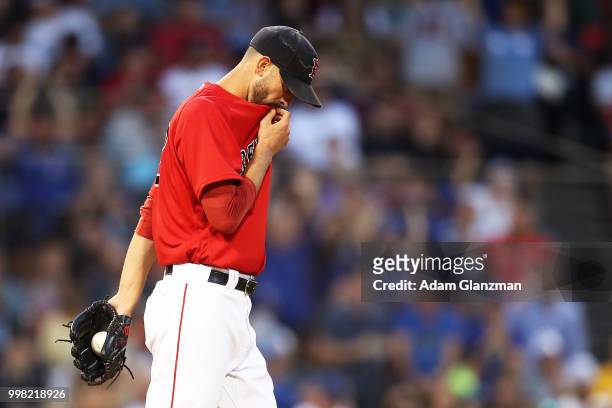 Rick Porcello of the Boston Red Sox reacts after giving up a two-run home run to Dwight Smith Jr. #27 of the Toronto Blue Jays in the third inning of...