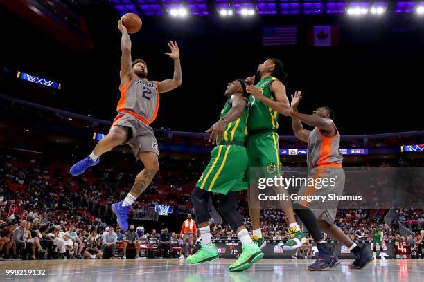 Andre Emmett of 3's Company attempts a shot past DeShawn Stevenson and Josh Childress of the Ball Hogs during BIG3 - Week Four at Little Caesars...