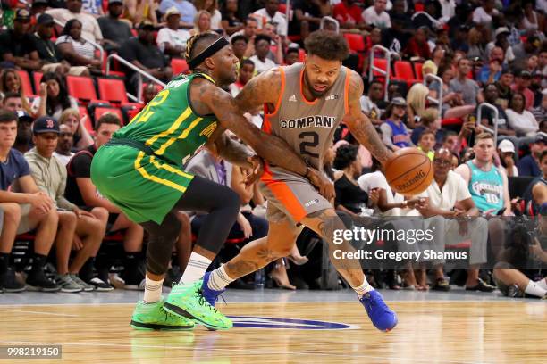 Andre Emmett of 3's Company dribbles the ball while being guarded by DeShawn Stevenson of the Ball Hogs during BIG3 - Week Four at Little Caesars...