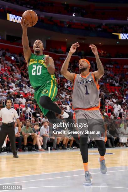 Andre Owens of the Ball Hogs attempts a shot while being guarded by DerMarr Johnson of 3's Company during BIG3 - Week Four at Little Caesars Arena on...