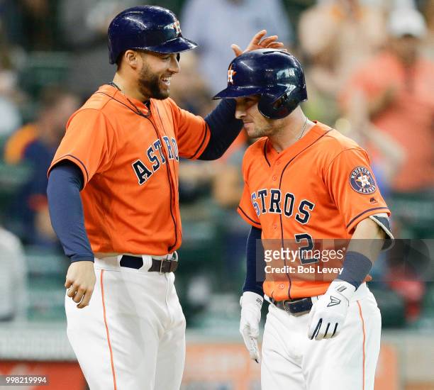 George Springer of the Houston Astros celebrates with Alex Bregman after Bregman hit a home run in the first inning against the Detroit Tigersat...