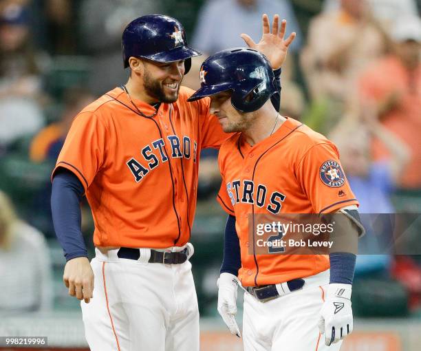 George Springer of the Houston Astros celebrates with Alex Bregman after Bregman hit a home run in the first inning against the Detroit Tigersat...