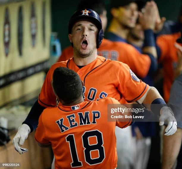 Alex Bregman of the Houston Astros receives a hug from Tony Kemp after hitting a two-run home run in the first inning against the Detroit Tigers at...
