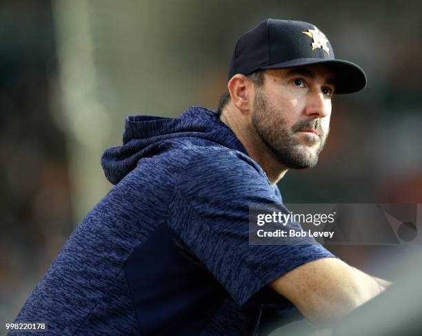 Justin Verlander of the Houston Astros looks on from the dugout as the Houston Astros play the Detroit Tigers at Minute Maid Park on July 13, 2018 in...