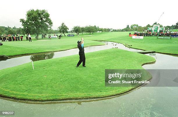 Mikael Lundberg of Sweden plays from the drop zone to the 18th green during the first round of the Lancome Trophy at the St-Nom-la-Breteche Golf...