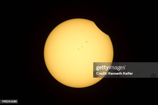 beginning stage solar eclipse of 2017 - eclipse foto e immagini stock
