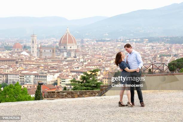 young couple dancing, santa maria del fiore in background, florence, toscana, italy - fiore stock pictures, royalty-free photos & images