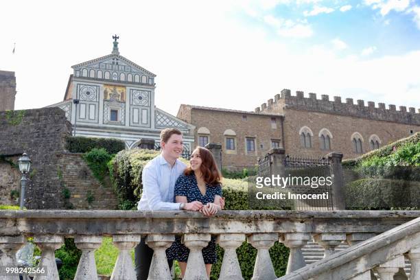 young couple relaxing by san miniato al monte church, florence, toscana, italy - san miniato photos et images de collection