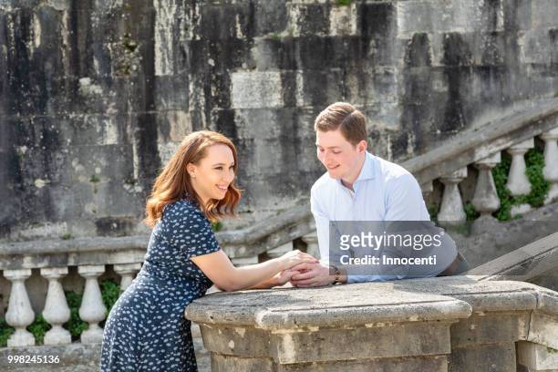young couple relaxing by san miniato al monte church, florence, toscana, italy - san miniato stock pictures, royalty-free photos & images