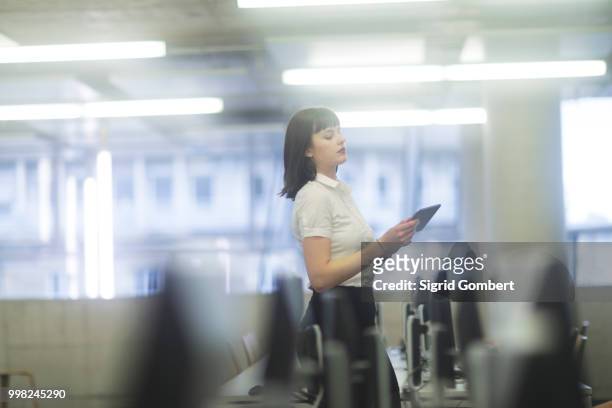 businesswoman in office using digital tablet - sigrid gombert fotografías e imágenes de stock