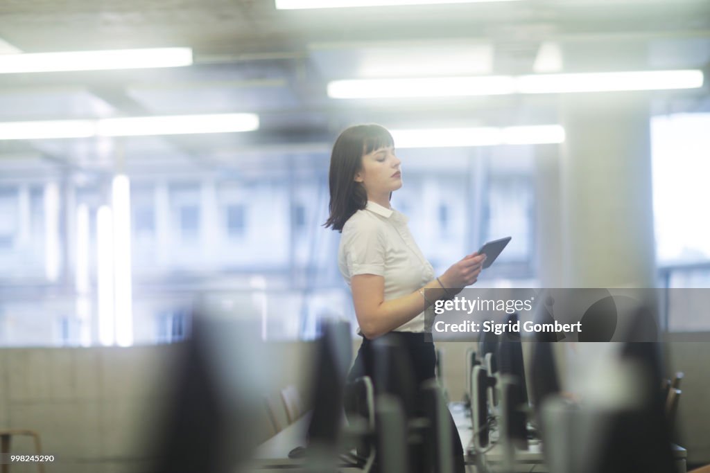 Businesswoman in office using digital tablet