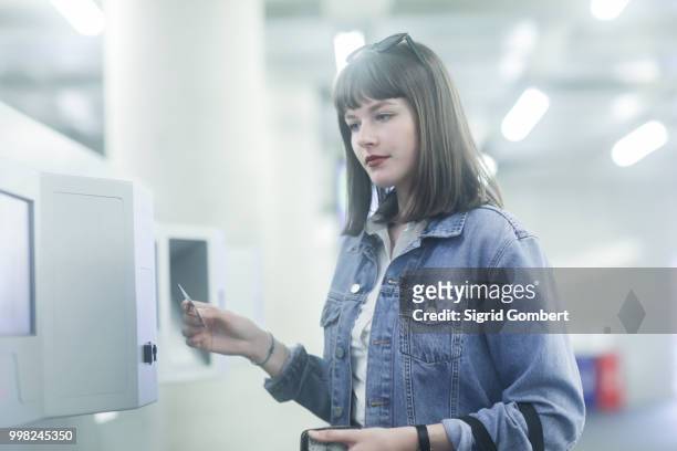 woman using identity card on security machine - sigrid gombert stock-fotos und bilder