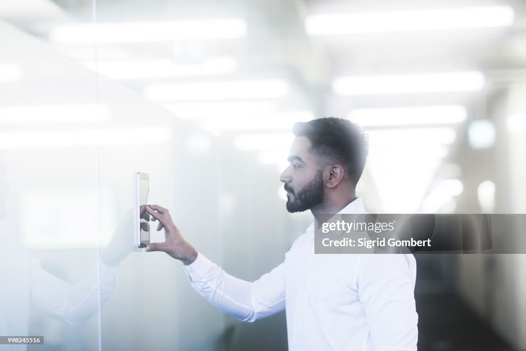 Young man using digital tablet in office