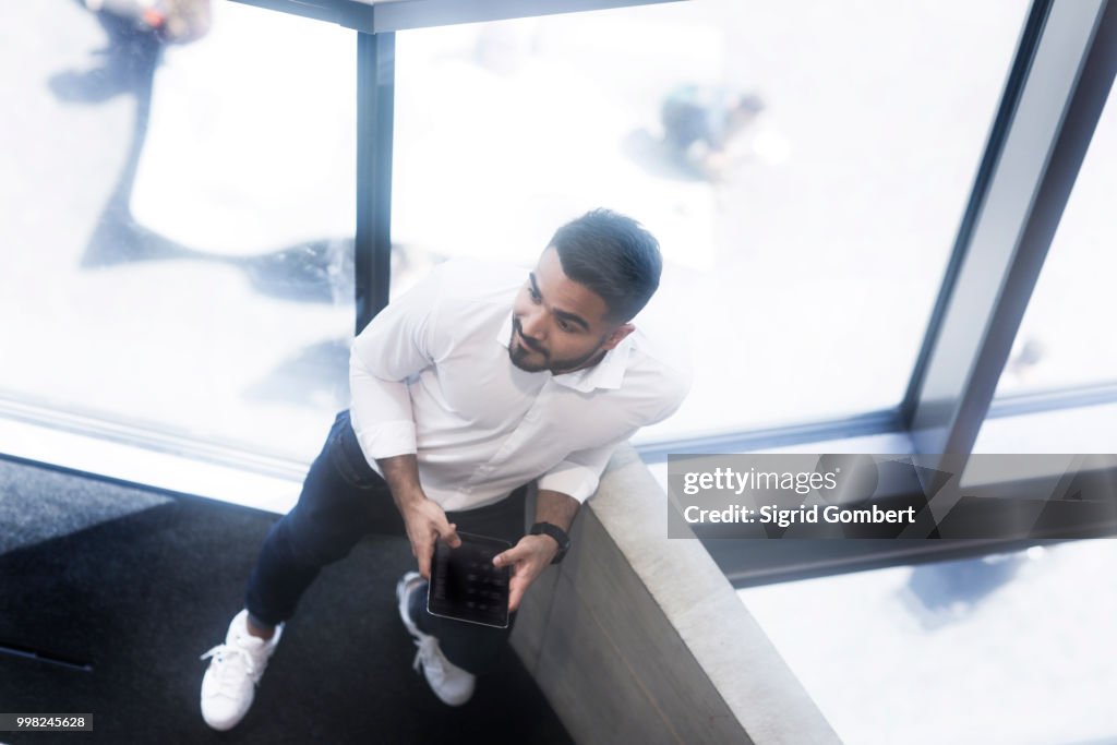 Young man using digital tablet in office