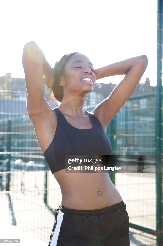 Young woman taking break in sports court
