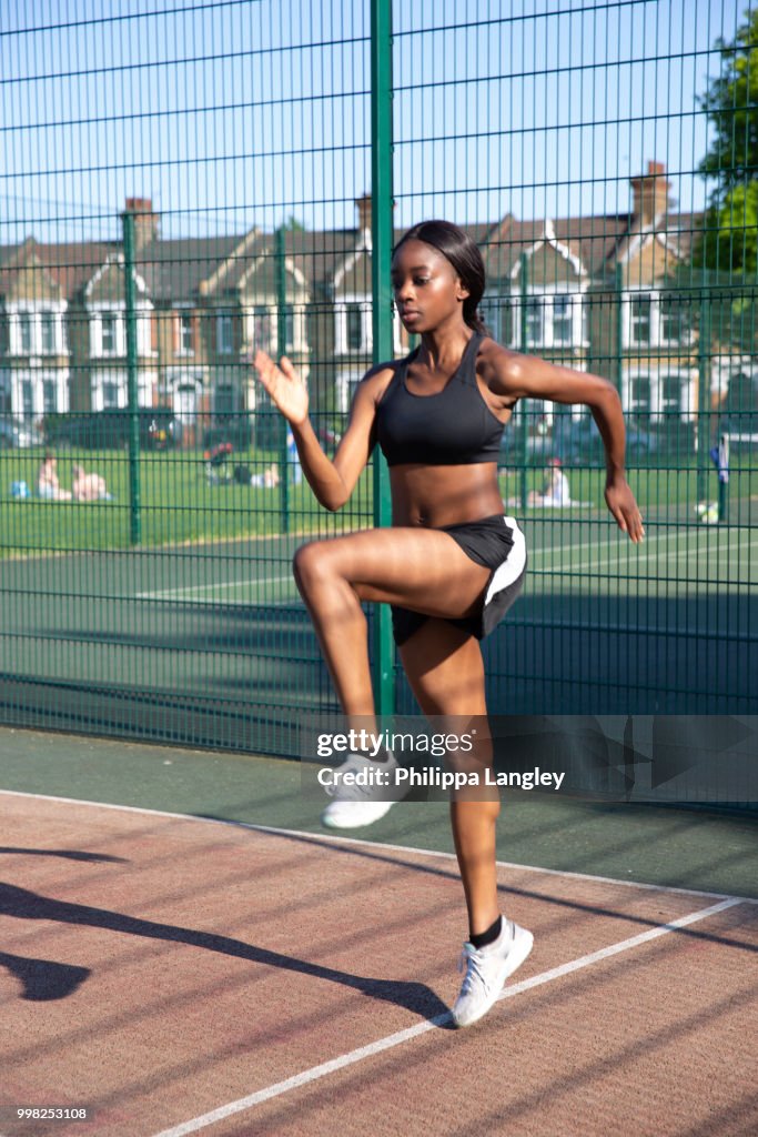 Young woman exercising in sports court