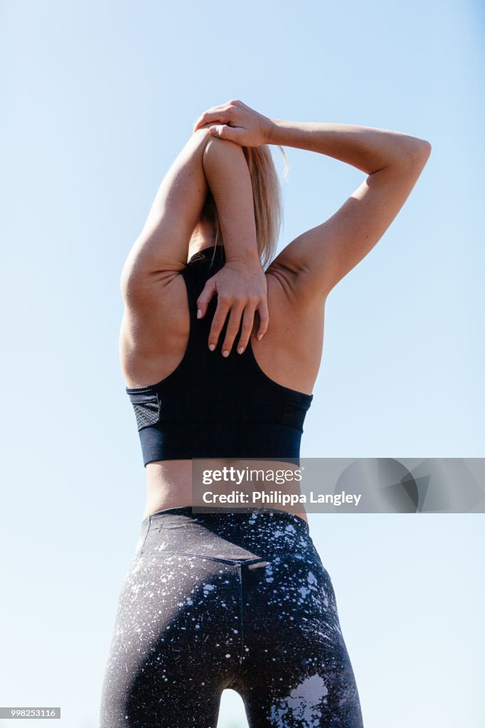 Young woman stretching arms