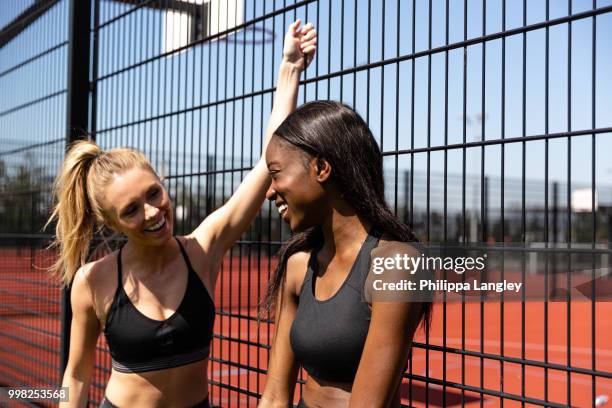 young women chatting by basketball court - langley city stock pictures, royalty-free photos & images