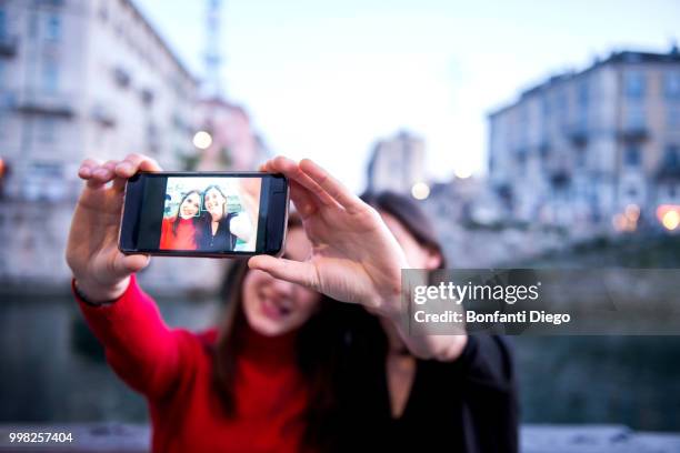 young women taking selfie, milan, lombardy, italy - diego rojas fotografías e imágenes de stock