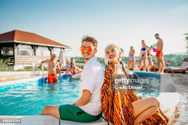 young couple enjoying at luxury resort swimming pool - drazen stock pictures, royalty-free photos & images