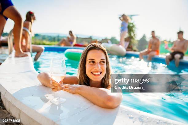 beautiful woman with glass of cockatil in swimming pool - drazen stock pictures, royalty-free photos & images