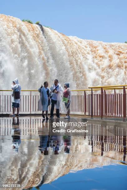 brazil tourists standing in front of waterfalls in iguacu on vacations - grafissimo stock pictures, royalty-free photos & images