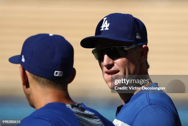 Chase Utley of the Los Angeles Dodgers talks with teammate Austin Barnes during batting practice prior to the MLB game against the Los Angeles Angels...