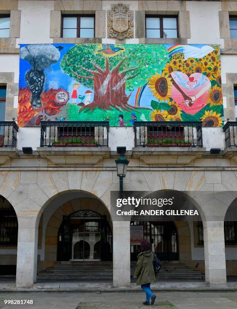 Woman walks in front of the Peace Museum in the Spanish Basque village of Guernica on May 4, 2018. - In Spain, the issue of remembrance is especially...