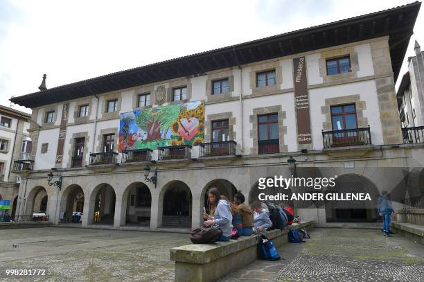 Children sit outside the Peace Museum in the Spanish Basque village of Guernica on May 4, 2018. - In Spain, the issue of remembrance is especially...