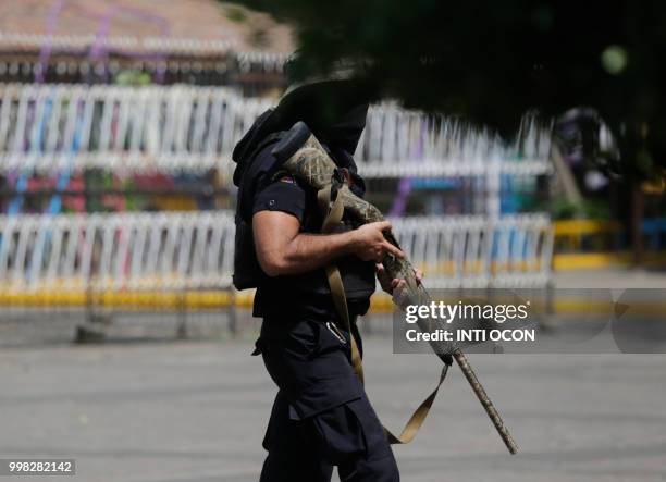 Member of the police forces confronts anti-government demonstrators at Monimbo neighbourhood in Masaya, some 35 km from Managua, on July 13, 2018...