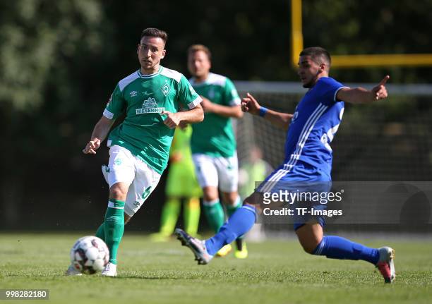 Kevin Moehwald of Werder Bremen and Tiago Moreira of Eintracht Cuxhaven battle for the ball during the friendly match between FC Eintracht Cuxhaven...