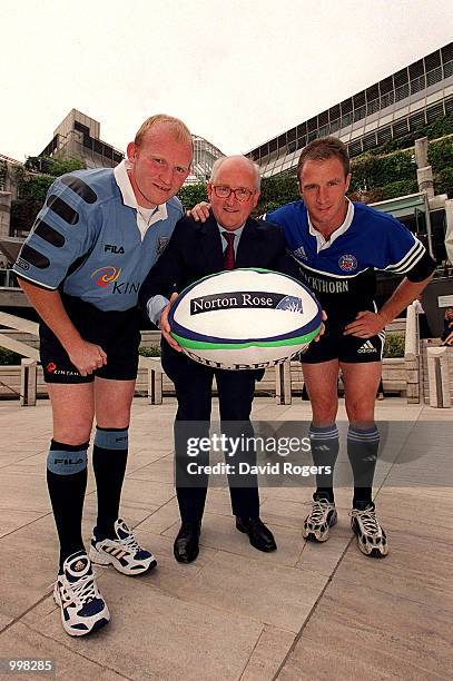 Neil Jenkins of Cardiff and Mike Catt of Bath pose with Roger Birkby, Managing Partner of International law firm Norton Rose, at a photocall in...