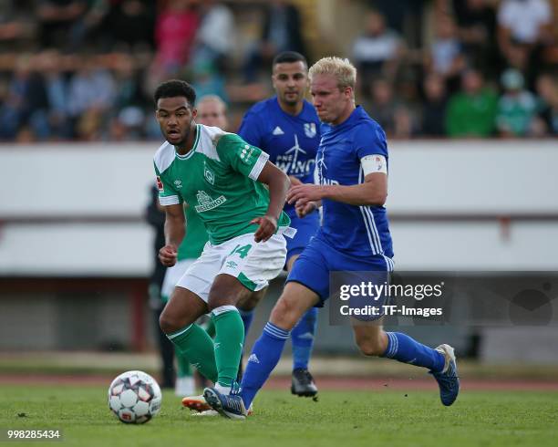 Manuel Mbom of Werder Bremen and Kai Dombrowski of Eintracht Cuxhaven battle for the ball during the friendly match between FC Eintracht Cuxhaven and...