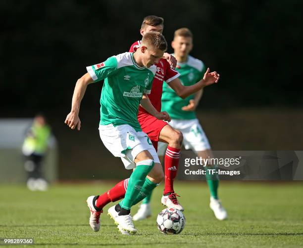 Aron Johannsson of Werder Bremen and Dominique Schmiedel of Bremerhaven battle for the ball during the friendly match between OSC Bremerhaven and...