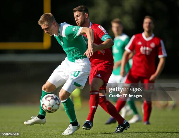 Aron Johannsson of Werder Bremen and Igro Casanova of Bremerhaven battle for the ball during the friendly match between OSC Bremerhaven and Werder...