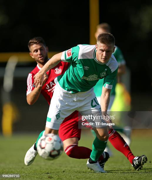 Igro Casanova of Bremerhaven and Aron Johannsson of Werder Bremen battle for the ball during the friendly match between OSC Bremerhaven and Werder...